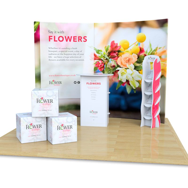 3m x 3m fabric exhibition stand includes fabric curved backdrop with foam cubes, Rockport counter and Hexby leaflet dispenser