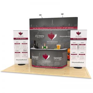 4m x 4m Jumbo Exhibition Stand Design includes a 2.9m High backdrop, 2 roller banners and double exhibition counter